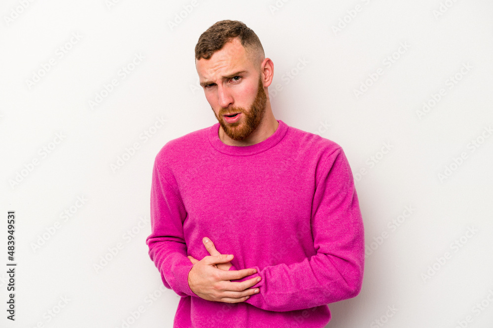 Young caucasian man isolated on white background having a liver pain, stomach ache. Young caucasian man isolated on white background having a liver pain, stomach ache.