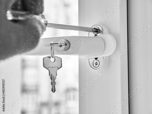 An employee installs a child-safe window handle. photo