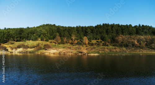 Landscape view of pine trees from over the Bayramic dam lake © ardasavasciogullari