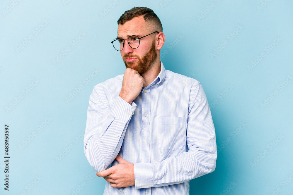 Young caucasian man isolated on blue background suffers pain in throat due a virus or infection. Young caucasian man isolated on blue background suffers pain in throat due a virus or infection.