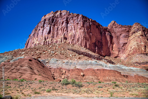 Red Mountains in Capitol Reef National Park under a blue summer sky.