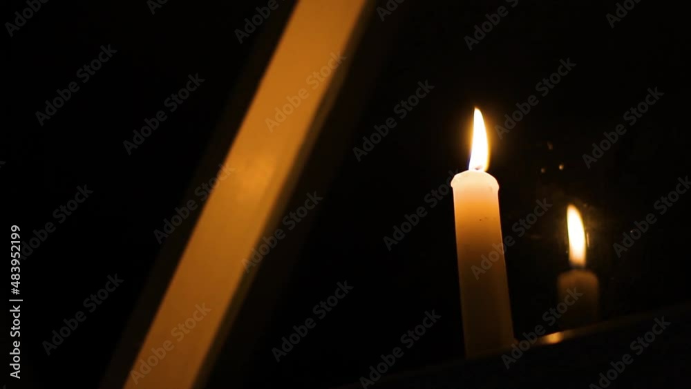 Burning candle in the dark