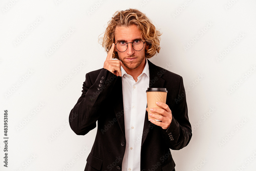 Young caucasian business man holding coffee isolated on white background pointing temple with finger, thinking, focused on a task. Young caucasian business man holding coffee isolated on white background pointing temple with finger, thinking, focused on a task.