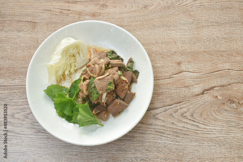 spicy slice pork liver Thai salad eat with fresh Gotu kolal leaf and cabbage on plate spicy slice pork liver Thai salad eat with fresh Gotu kolal leaf and cabbage on plate