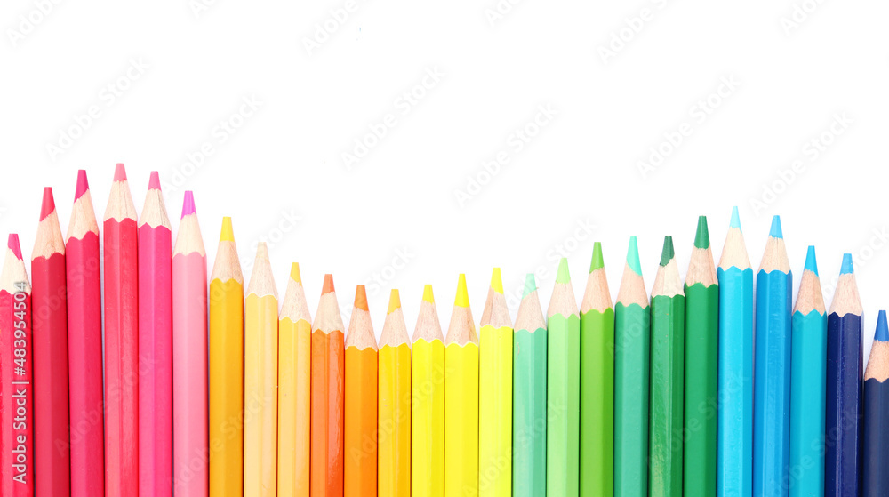 Colored pencils lined up on white paper background. Copy space. Back to school. Office supplies. Colored pencils lined up on white paper background. Copy space. Back to school. Office supplies.