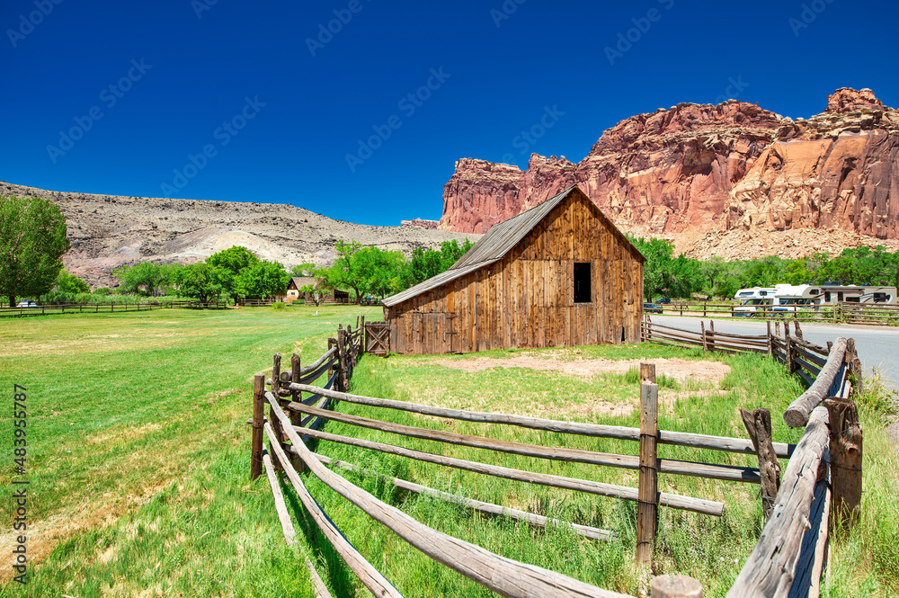 Wooden hut in Capitol Reef National Park under a blue summer sky.