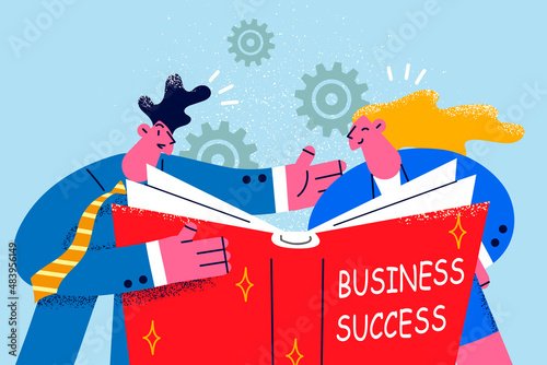 Happy colleagues read book about business success 