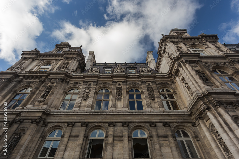 Looking up at a large French government building with ornate decorations