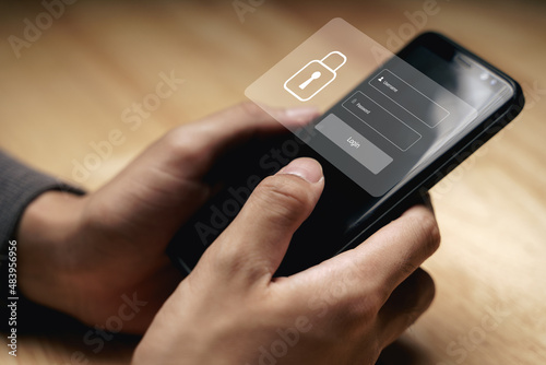 Wallpaper Mural Businessman protecting personal data on the smartphone with Login virtual interfaces. Lock icon and internet network security technology. Cybersecurity and privacy concepts. Torontodigital.ca