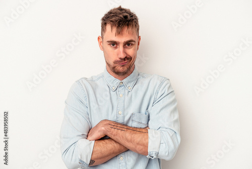 Young caucasian man isolated on white background confused, feels doubtful and unsure. © Asier