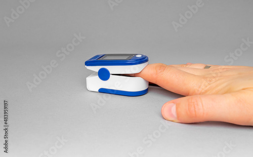 Pulse oximeter on a female hand. Controlling the level of oxygen in the body.