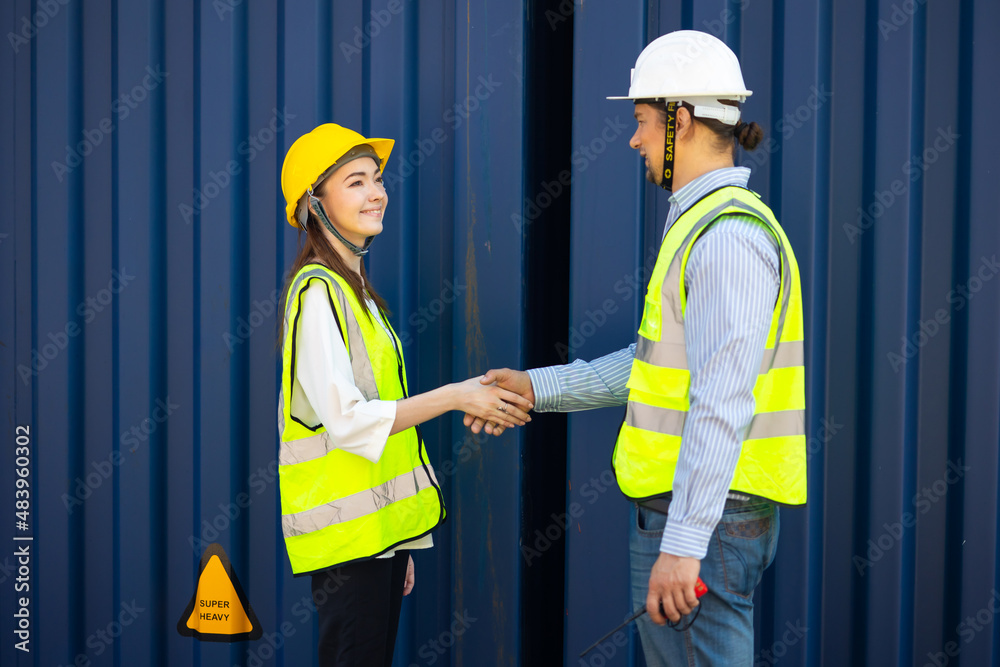 Caucasian Man manager and woman Supervisor dock cargo handshaking after good deal at container yard port of import and export goods. Unity and teamwork concept Caucasian Man manager and woman Supervisor dock cargo handshaking after good deal at container yard port of import and export goods. Unity and teamwork concept