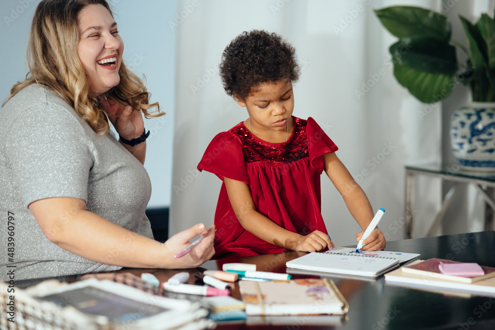 Mother and child daughter draws creatively at the table Mother and child daughter draws creatively at the table