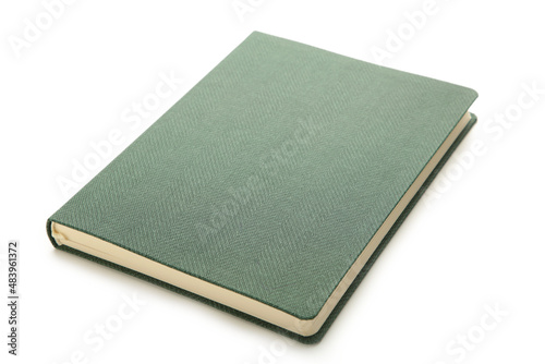 Green notebook isolated on white background. photo