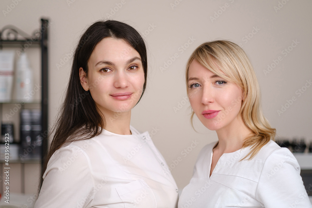 Portrait of a two young beautiful women cosmetologists in the interior of a beauty salon. Portrait of a two young beautiful women cosmetologists in the interior of a beauty salon.