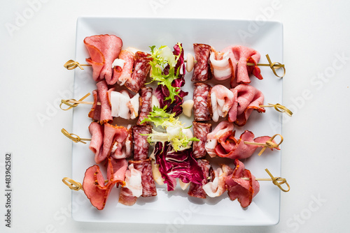 meat appetizers on the white plate photo