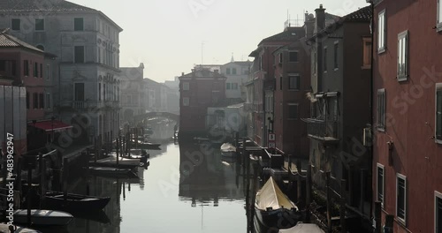 Chioggia town in venetian lagoon, water canal. Chioggia is a seaside town south of Venice, Italy. Traversed by the Corso del Popolo thoroughfare, its historic area has canals and narrow alleys.