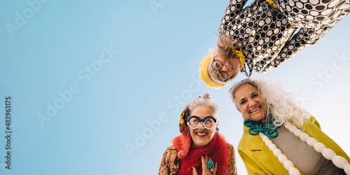 Low angle view of happy senior women smiling at the camera