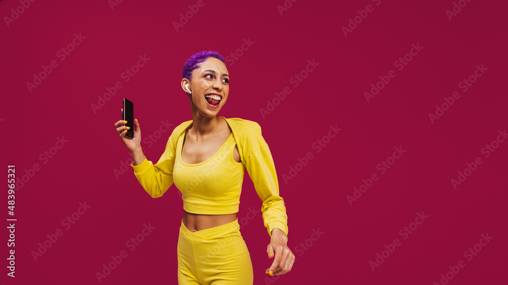 Hipster woman streaming music on her smartphone