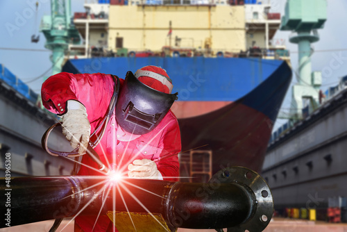 Industry Welder Welding process metal steel pipe by TIG inert gas at floating dock yard in shipyard protective equipment wearing for safety,