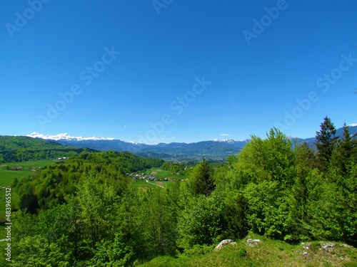Beautiful panoramic view of Gorenjska, Slovenia with forests and snow covered mountain peak of Triglav mountain