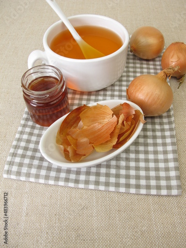 A cup of onion peel tea with honey