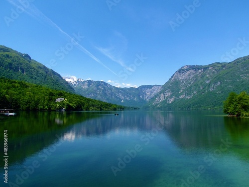 Scenic view of Bohinj lake in Gorenjska, Slovenia in Julian alps and Triglav national park in summer with a reflection of the mountains in the lake