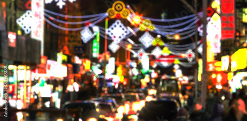 Blurred abstract lights of a busy New York City nighttime street scene in Chinatown