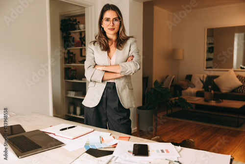 Confident interior designer standing in her home office photo