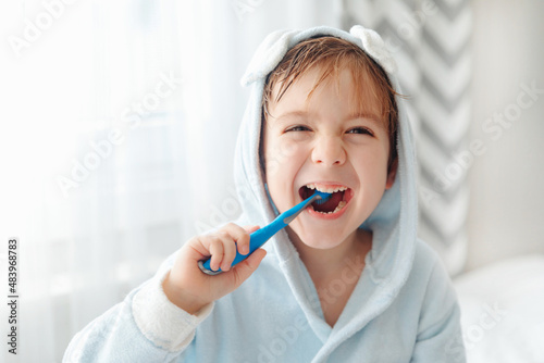 Slika na platnu Portrait of smiling happy child brushing teeth with toothbrush