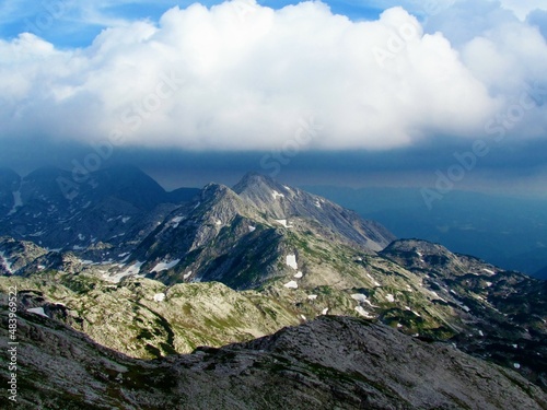 View of mountain Bogatin lit by sunlight and clouds above the mountain in Julian alps and Triglav national park, Slovenia photo