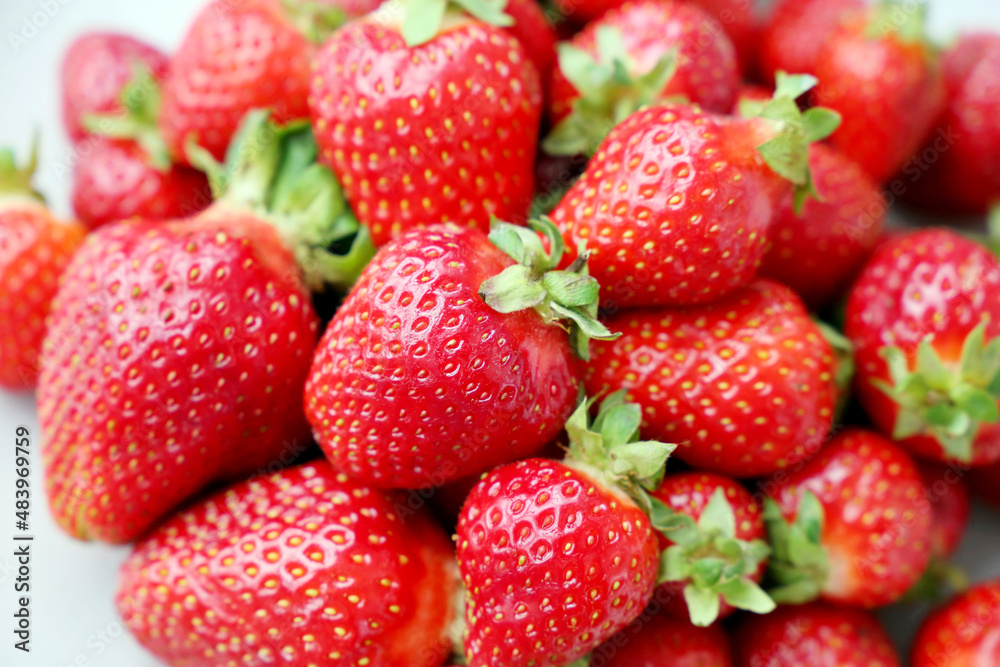 Fresh red strawberries with leaves. Pile of ripe strawberry for background Fresh red strawberries with leaves. Pile of ripe strawberry for background