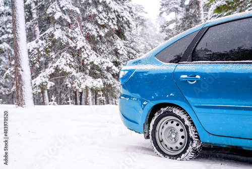 Blue car in winter snow forest
