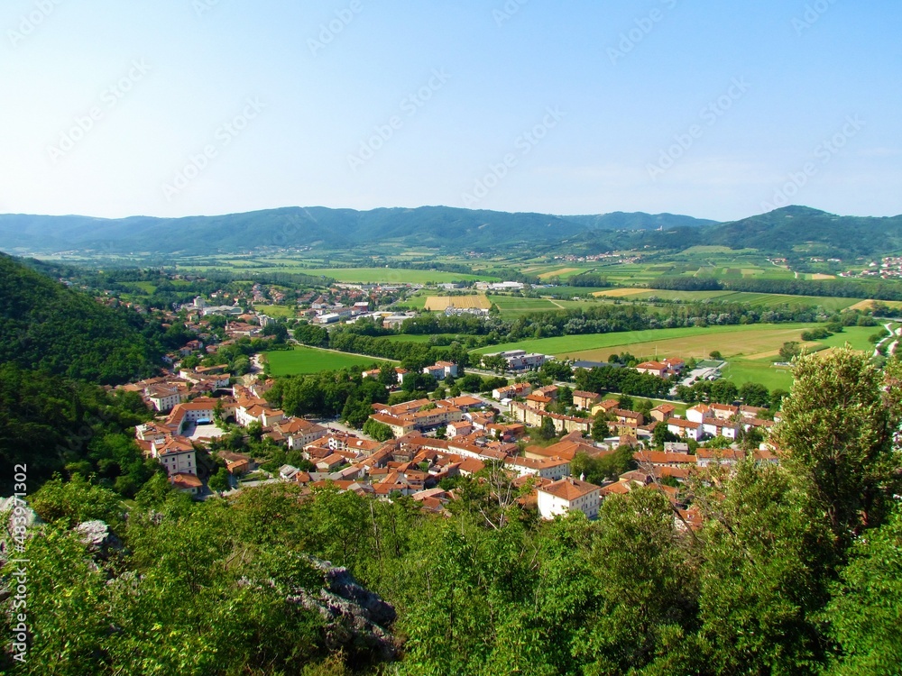 Beautiful view of a small town Vipava in Littoral region of Slovenia with red roofs, church in the middle and forest covered hills in the background