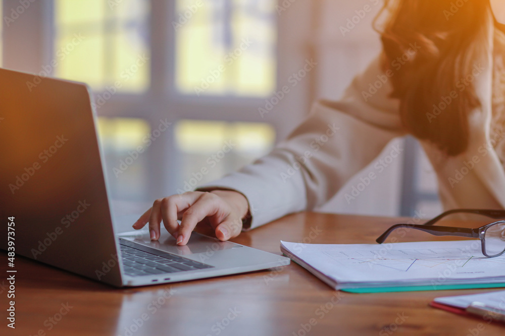 The businesswoman is reviewing the results from the documents prepared to report the earnings at a meeting to the investors about the annual profit. Young businesswoman checking annual results The businesswoman is reviewing the results from the documents prepared to report the earnings at a meeting to the investors about the annual profit. Young businesswoman checking annual results