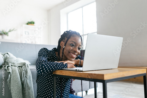 Beautiful young black woman has a zoom call remote work or study online in from laptop classes