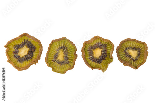 close-up, dried pieces of kiwi fruit of different sizes, laid out in a row, on a white background