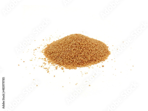 Whole and raw couscous on white background. Handful of whole wheat grits isolated. Pile of dry couscous. Arab, oriental healthy and organic food.