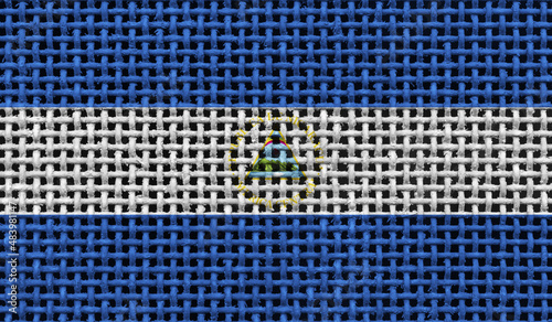 Nicaragua flag on the surface of a metal lattice. 3D image