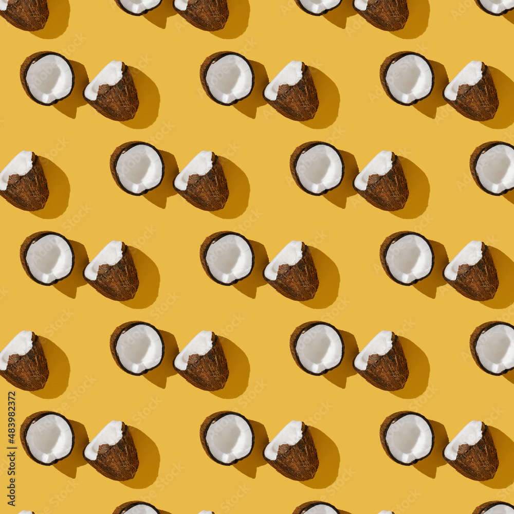 A pattern of coconuts on a bright yellow background. A pattern of coconuts on a bright yellow background.