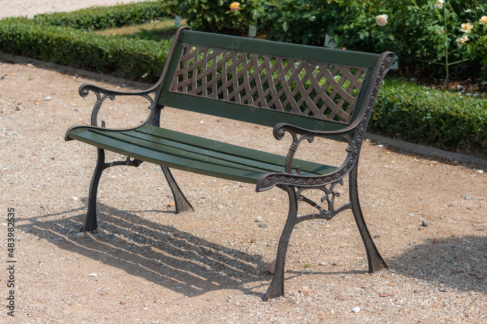 Old retro beautiful bench in the garden at summer season Old retro beautiful bench in the garden at summer season