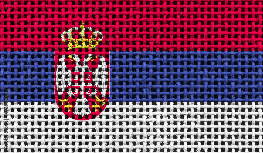 Serbia flag on the surface of a metal lattice. 3D image