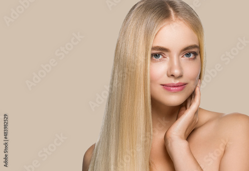Long smooth hair beauty woman portrait blonde hairstyle. Touching her face. Color background. Brown.
