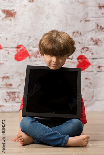little Boy holding a blank sign with a heart background black box  valentines day 
