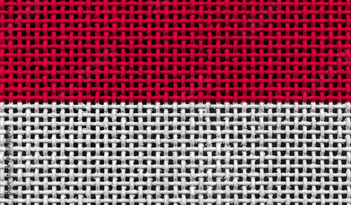 Monaco flag on the surface of a metal lattice. 3D image