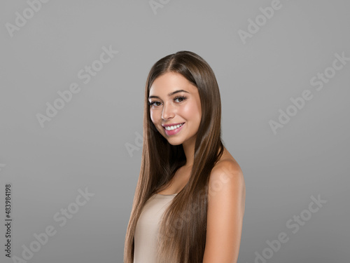 Beautiful freckles woman healthy hair long smooth brunette hairstyle Color background Gray