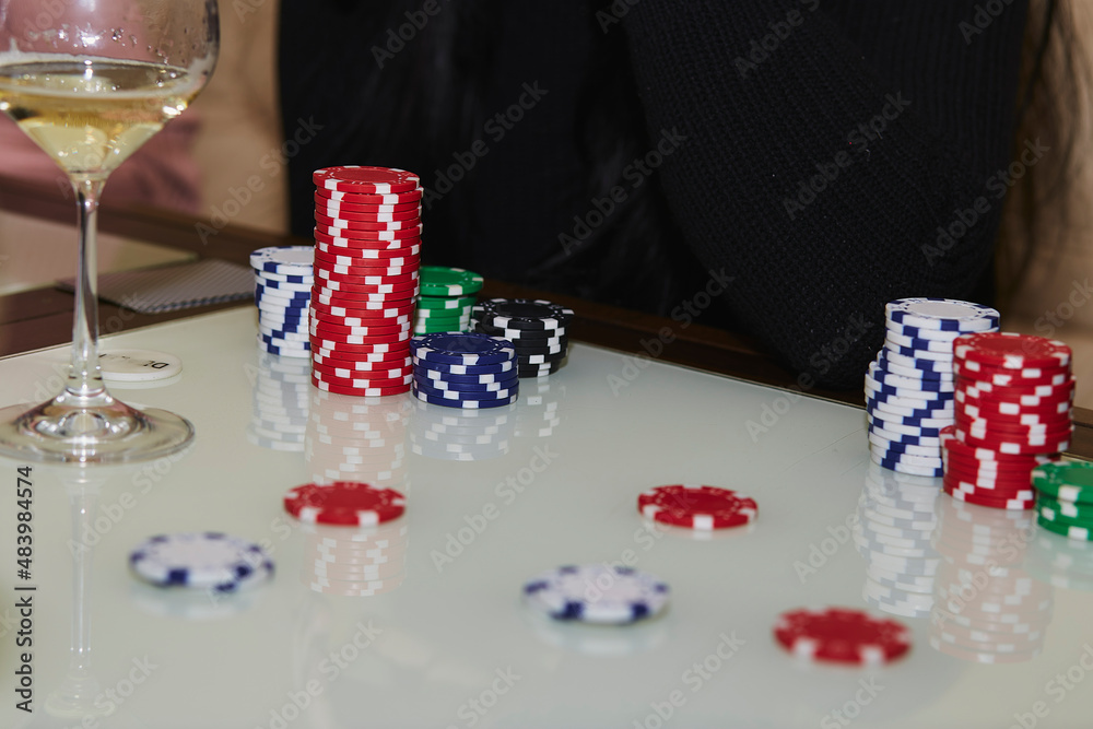 Poker game with dices and cards on the white table. Glasess of champagne. Candid moment. Poker background lifestyle photography. Enjoying the moment, digital detox with friends Poker game with dices and cards on the white table. Glasess of champagne. Candid moment. Poker background lifestyle photography. Enjoying the moment, digital detox with friends
