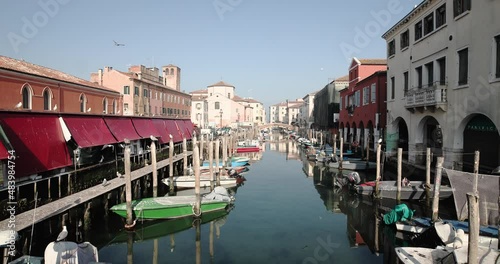 Chioggia town in venetian lagoon, water canal. Chioggia is a seaside town south of Venice, Italy. Traversed by the Corso del Popolo thoroughfare, its historic area has canals and narrow alleys.