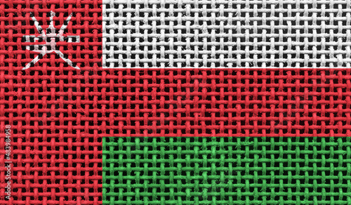 Oman flag on the surface of a metal lattice. 3D image