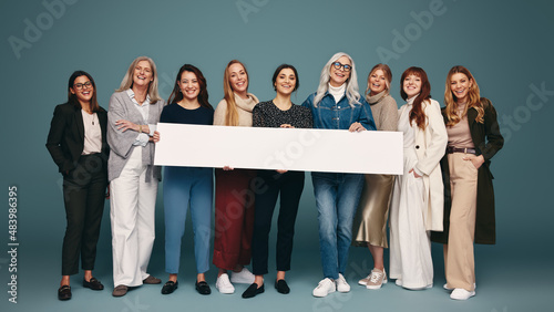 Women of different ages holding a pro-women banner photo